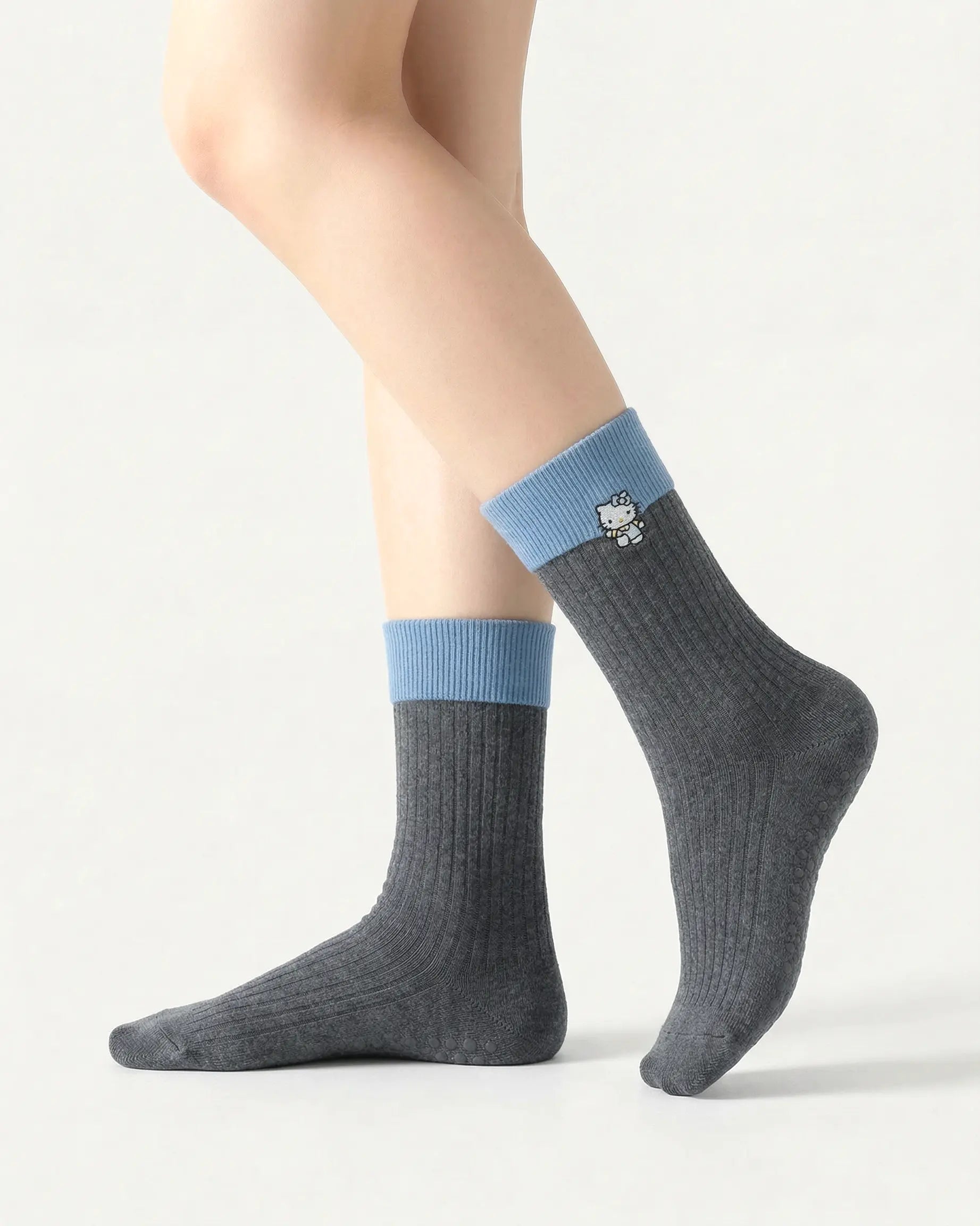 dark-grey | 01 | Dark grey character embroidery crew grip socks side standing view showing contrast black cuff, ribbed knit texture, and cat embroidery detail
