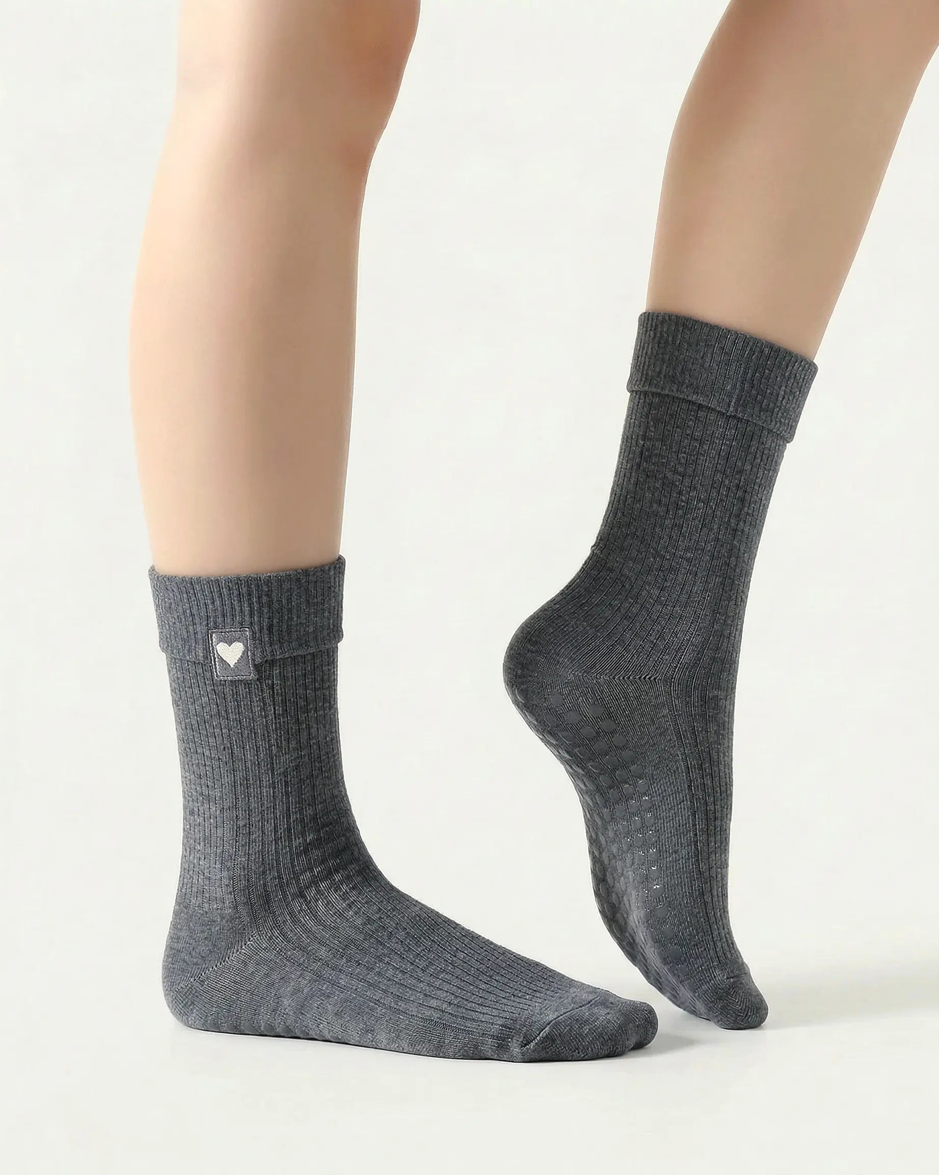 dark-grey | 03 | Dark-grey heart detail crew grip socks side pointed standing view showing crew length, ribbed texture, and minimal studio styling