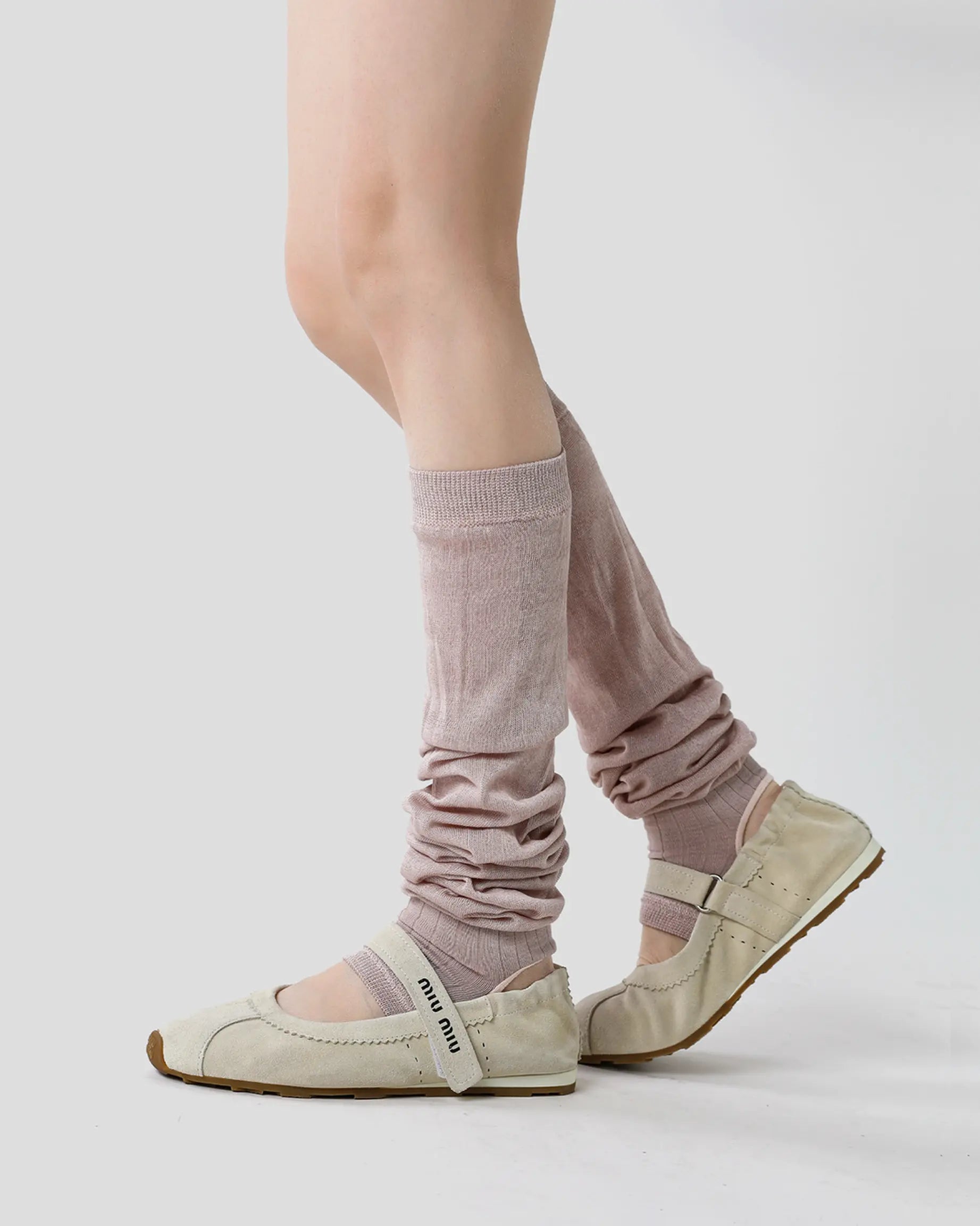 dusty-mauve | 03 | Dusty mauve ballet stirrup leg warmers side standing view styled with light ballet flats, showing the gathered calf shape and stirrup construction