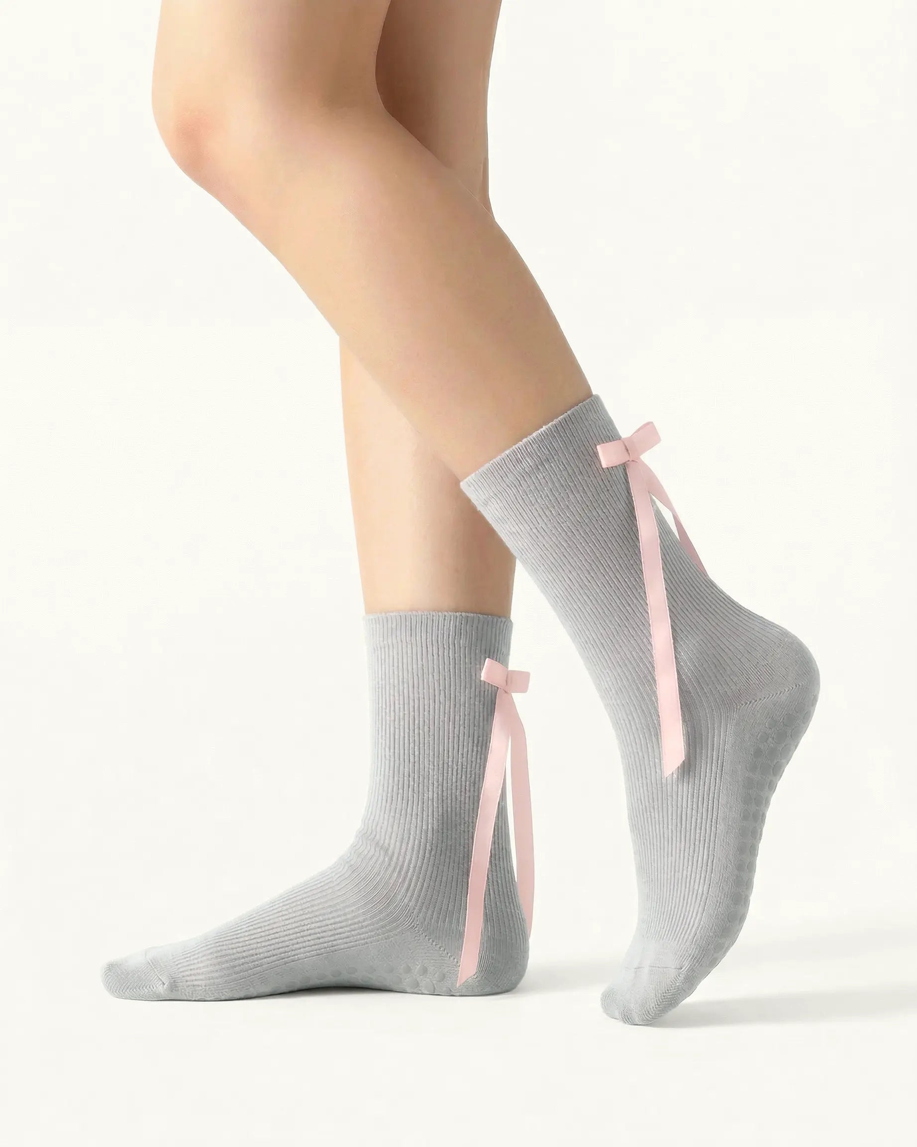 light-grey | 01 | Light grey ballet ribbon crew grip socks side standing view showing ribbed knit texture, long ribbon bow detail, and ballet-inspired crew silhouette