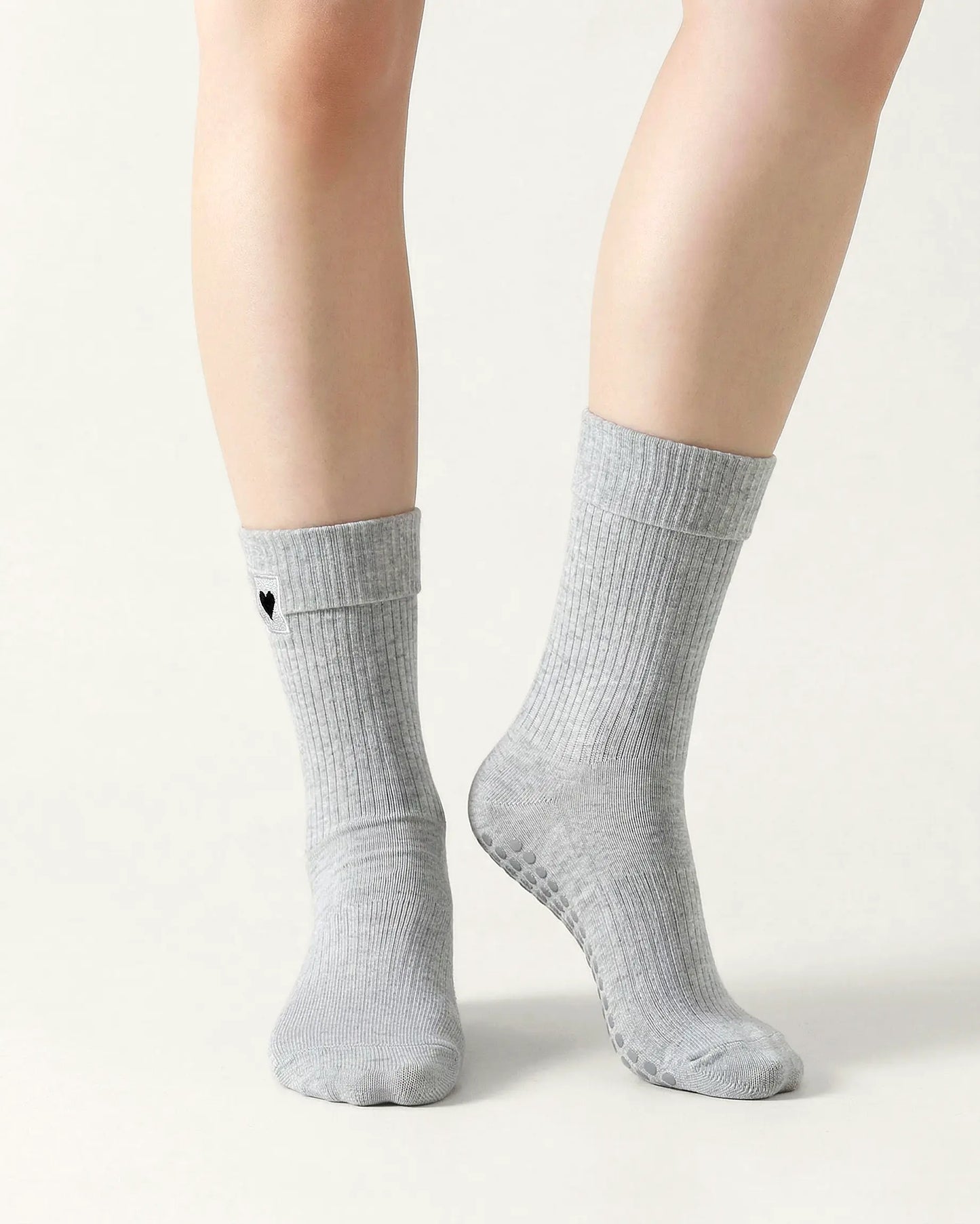 light-grey | 04 | Light grey heart detail crew grip socks front standing view showing fold-over cuff, black heart embroidery, and clean non-slip crew sock silhouette