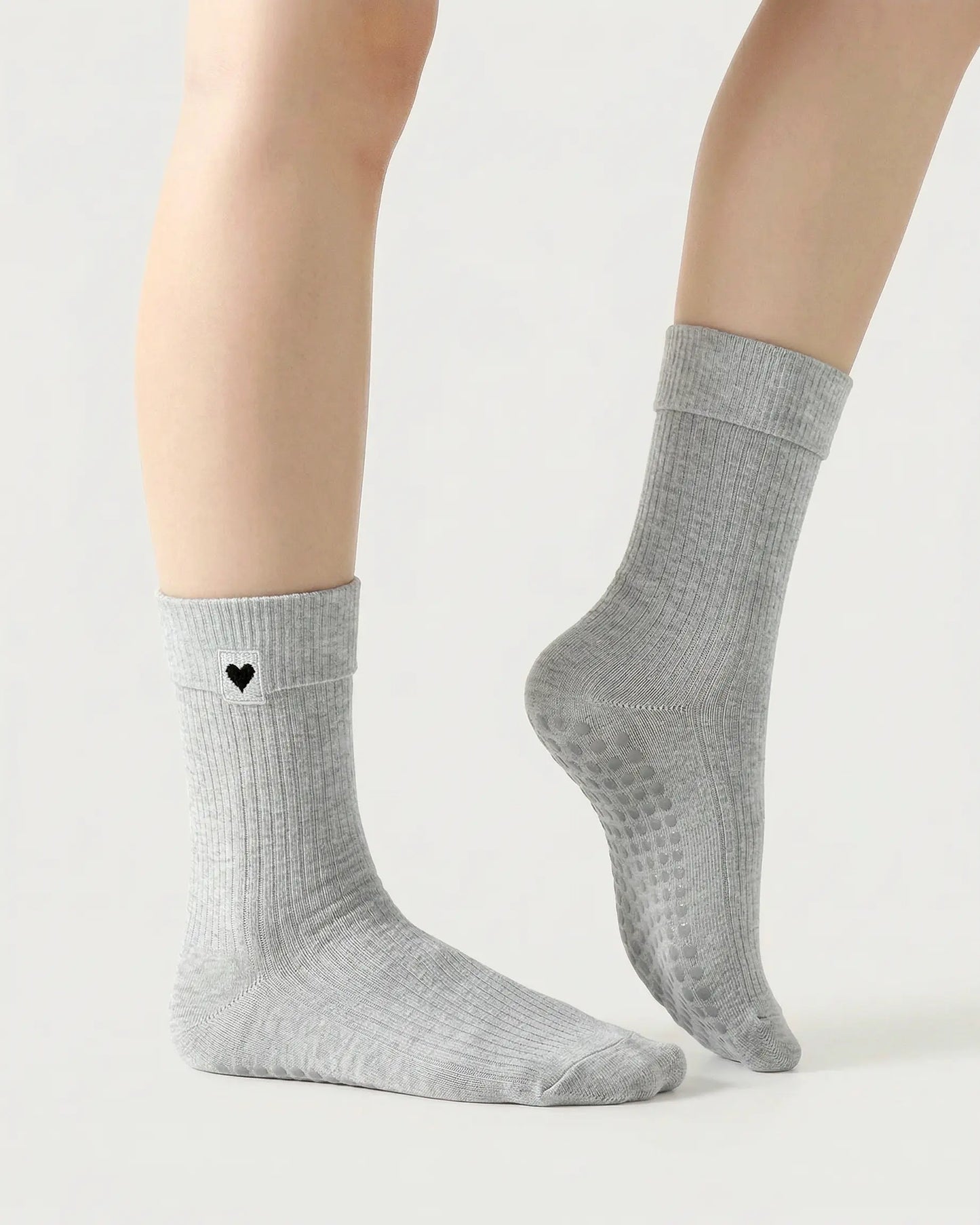 light-grey | 03 | Light grey heart detail crew grip socks side pointed standing view showing crew length, ribbed texture, and minimal studio styling