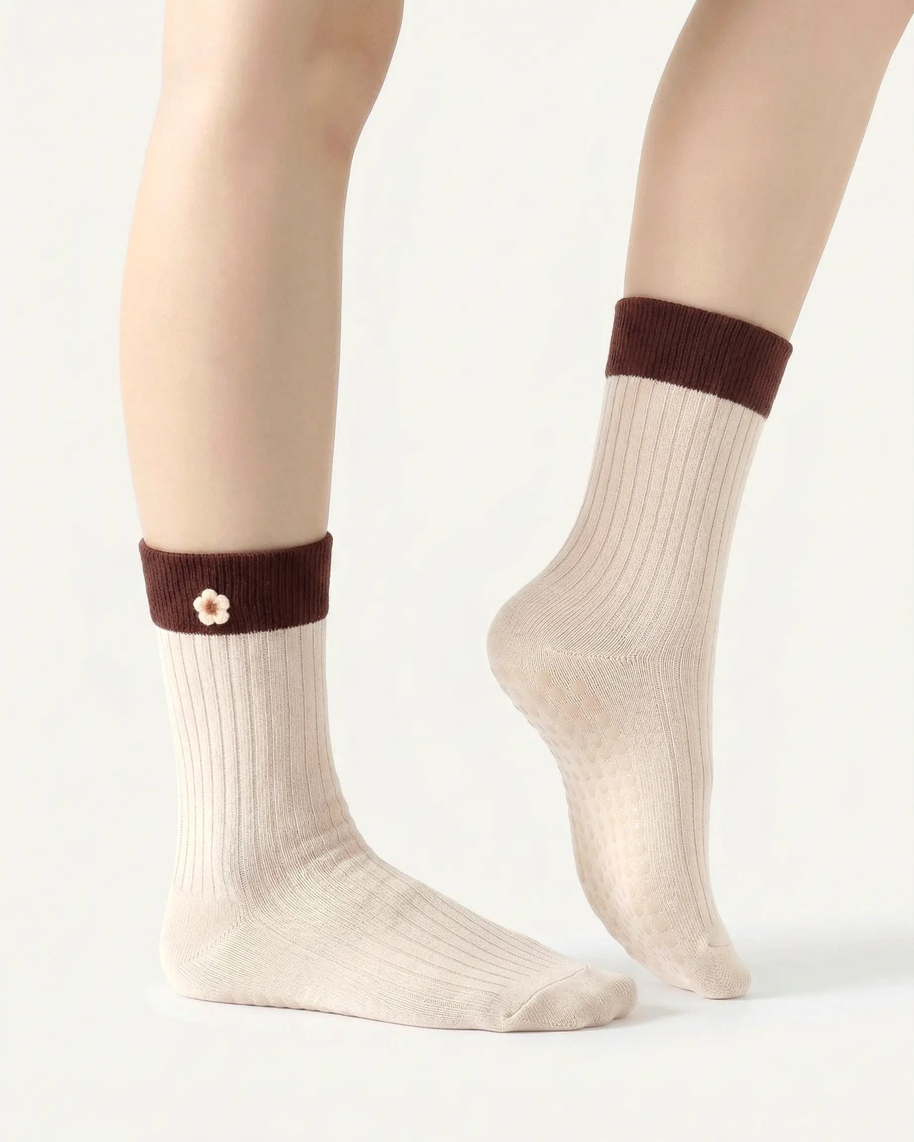 white-apricot | 03 | White apricot floral detail crew grip socks side detail view showing fold-over contrast cuff, ribbed crew silhouette, and floral embroidery accent