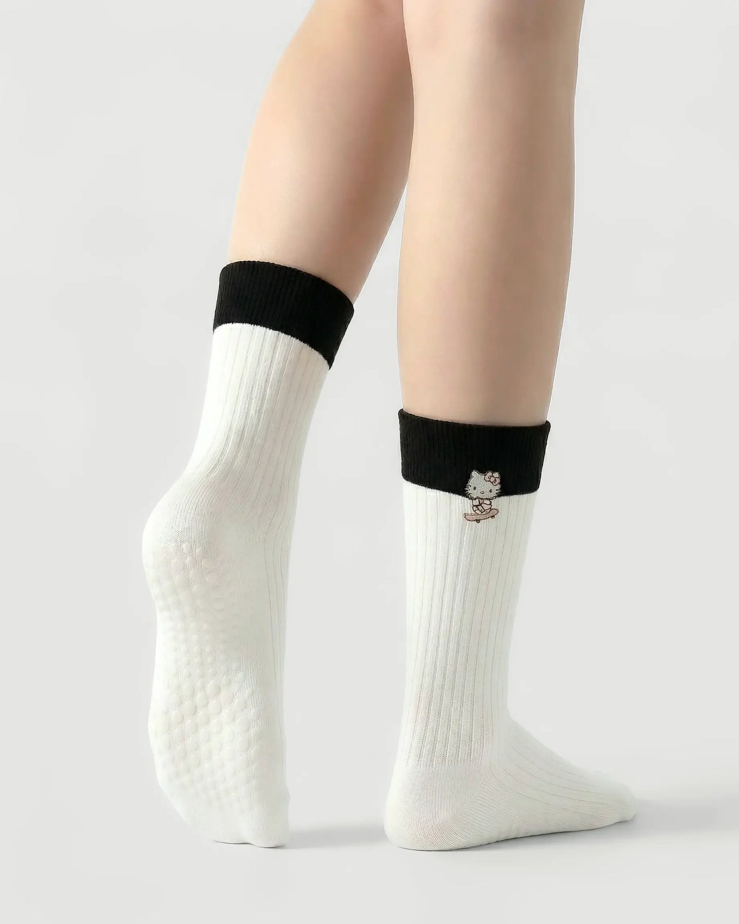 white | 02 | White character embroidery crew grip socks back side view showing grip sole detail, contrast black cuff, and embroidered cat motif