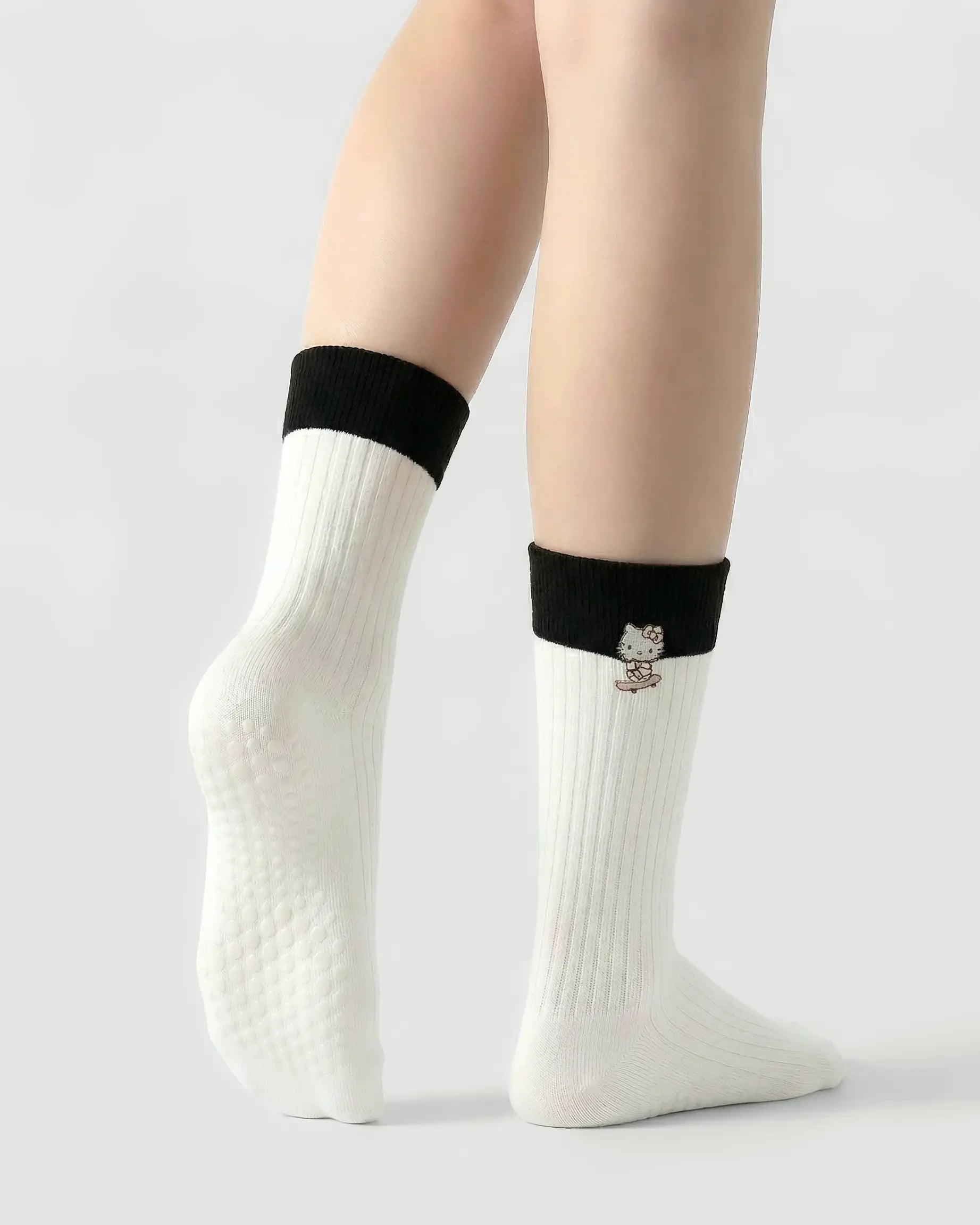 white | 02 | White character embroidery crew grip socks back side view showing grip sole detail, contrast black cuff, and embroidered cat motif
