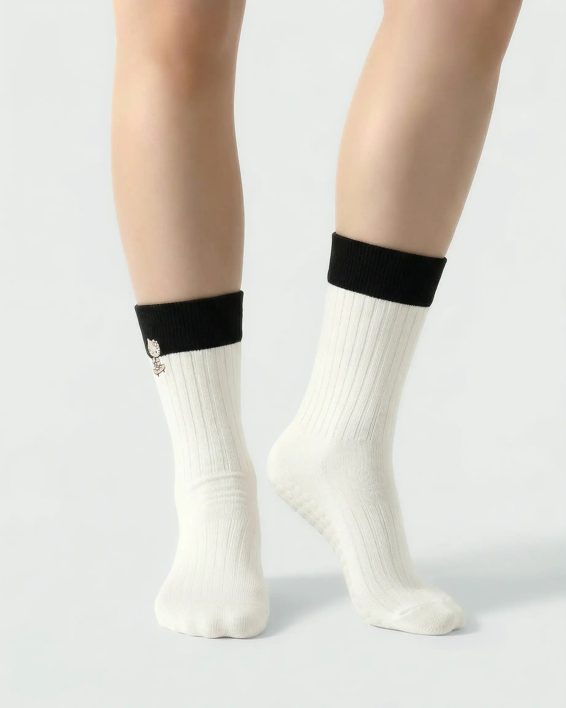 white | 04 | White character embroidery crew grip socks front standing view showing contrast cuff, ribbed knit texture, and clean non-slip crew sock shape