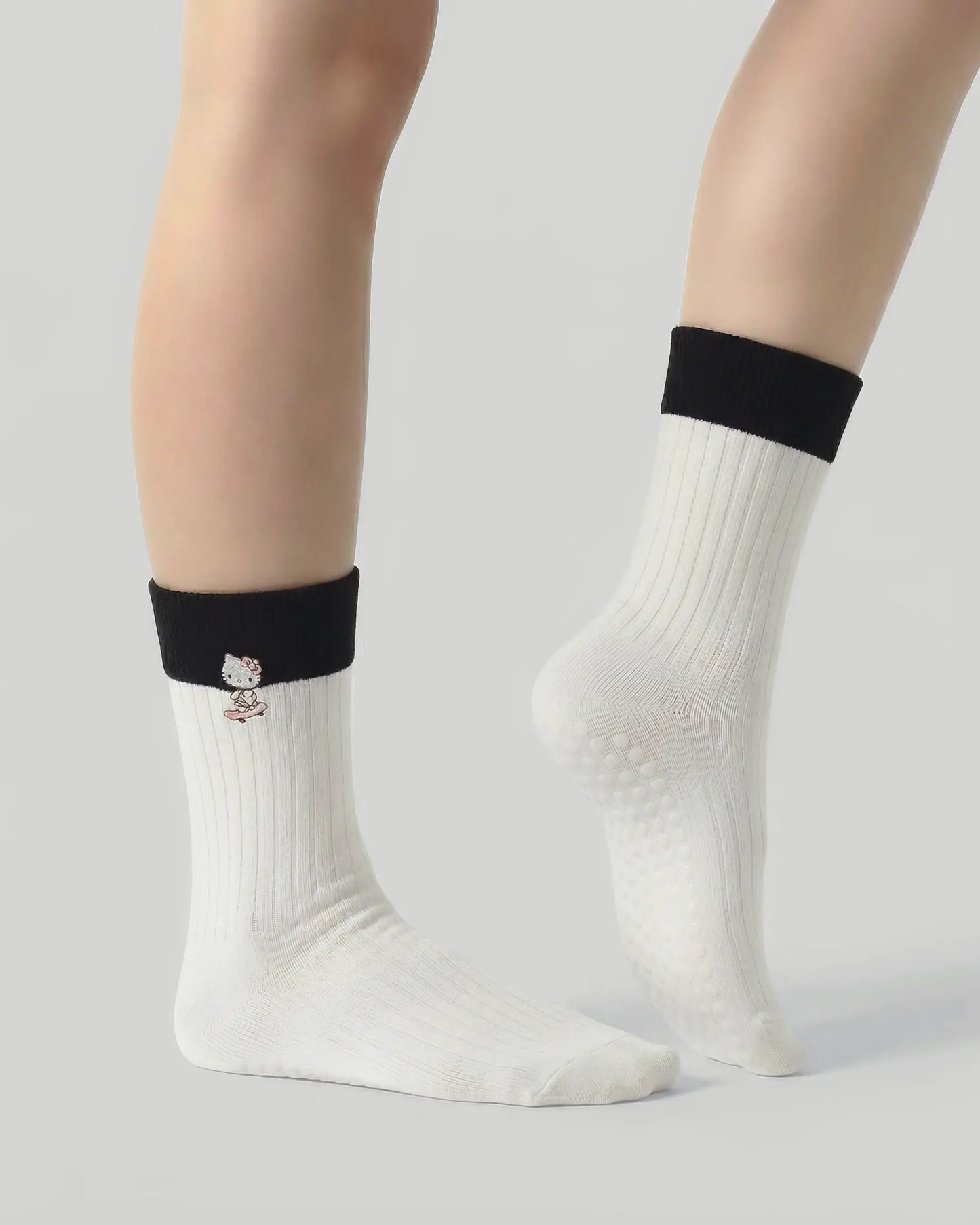 white | 03 | White character embroidery crew grip socks side pointed standing view showing contrast cuff, clean crew silhouette, and cat embroidery detail