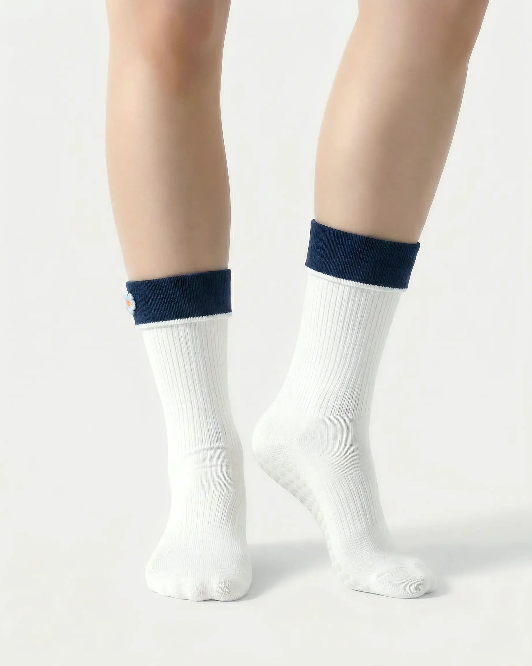 white | 04 | White floral detail crew grip socks front standing view showing clean crew shape, contrast cuff, and minimal non-slip sock styling
