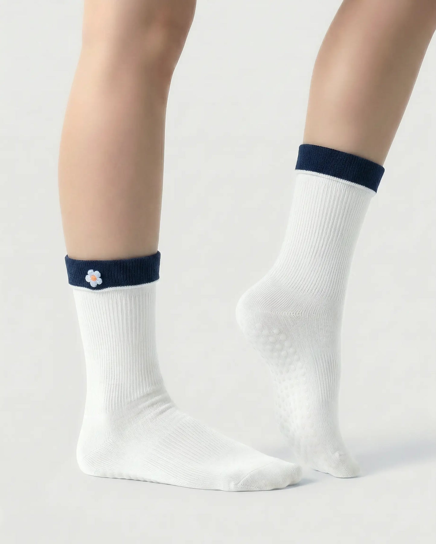 white | 03 | White floral detail crew grip socks side detail view showing fold-over contrast cuff, ribbed crew silhouette, and floral embroidery accent