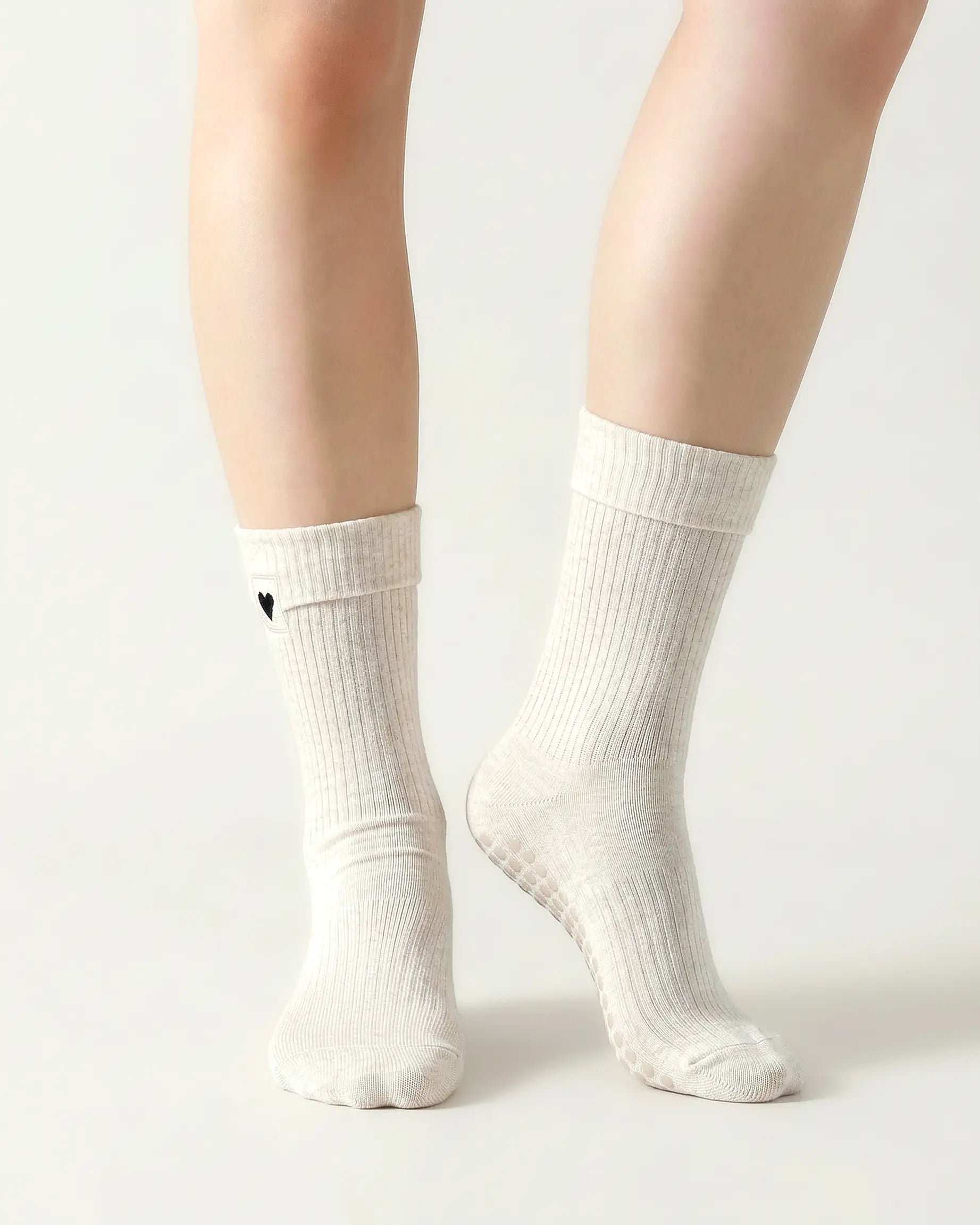 white | 04 | White heart detail crew grip socks front standing view showing fold-over cuff, black heart embroidery, and clean non-slip crew sock silhouette